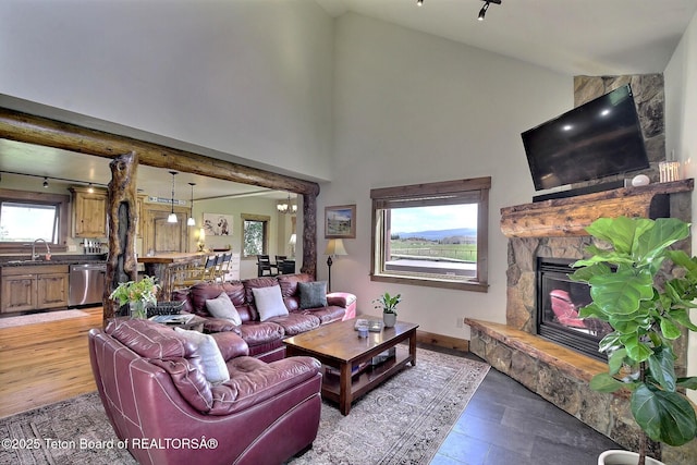 2160 Tomahawk Trl, Victor, ID 83455 - living area with light wood-style floors, a fireplace, and high vaulted ceiling