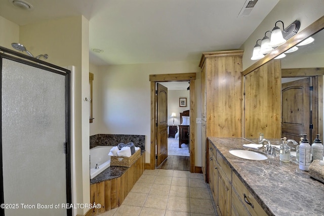 2160 Tomahawk Trl, Victor, ID 83455 - ensuite bathroom featuring a stall shower, tile patterned floors, vanity, and a garden tub