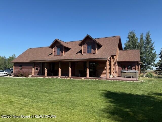 2160 Tomahawk Trl, Victor, ID 83455 - view of front of house featuring a front yard, covered porch, and log exterior