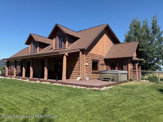 2160 Tomahawk Trl, Victor, ID 83455 - back of house featuring a hot tub, a patio, a yard, and log exterior
