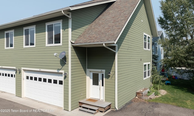 80 Eva Ln Unit 14, Victor, ID 83455 - view of front facade with an attached garage, roof with shingles, and driveway