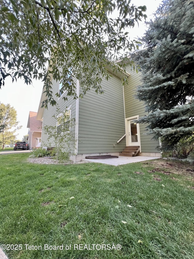 80 Eva Ln Unit 14, Victor, ID 83455 - view of home's exterior with entry steps, a yard, and a patio area