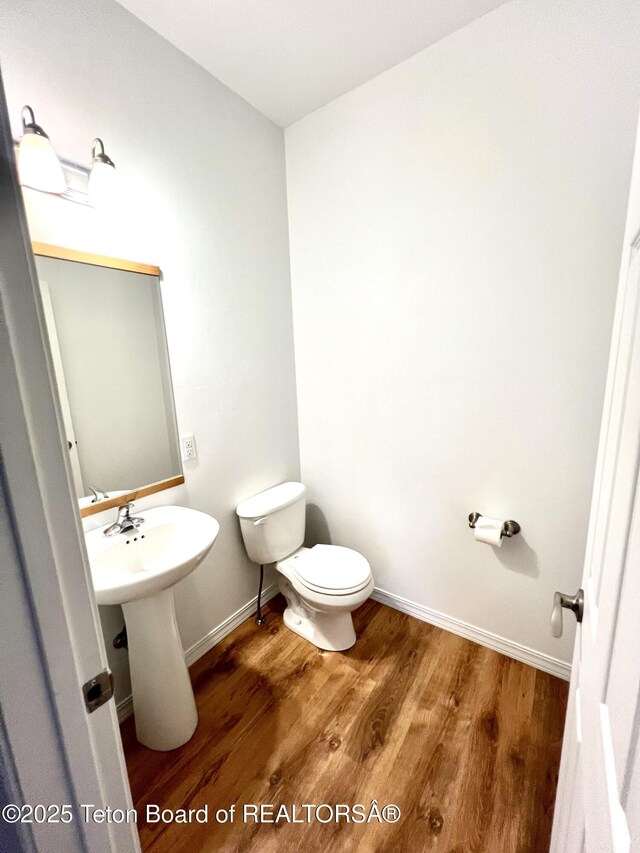 80 Eva Ln Unit 14, Victor, ID 83455 - half bathroom featuring toilet and wood finished floors