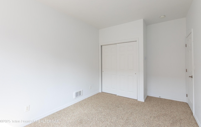 80 Eva Ln Unit 14, Victor, ID 83455 - unfurnished bedroom featuring light colored carpet and a closet