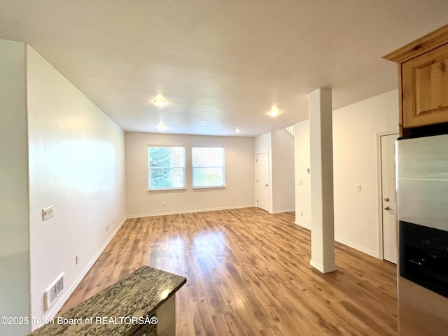 80 Eva Ln Unit 14, Victor, ID 83455 - unfurnished living room featuring light wood-style flooring and baseboards