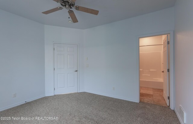 80 Eva Ln Unit 14, Victor, ID 83455 - unfurnished bedroom with carpet flooring, ensuite bathroom, and ceiling fan