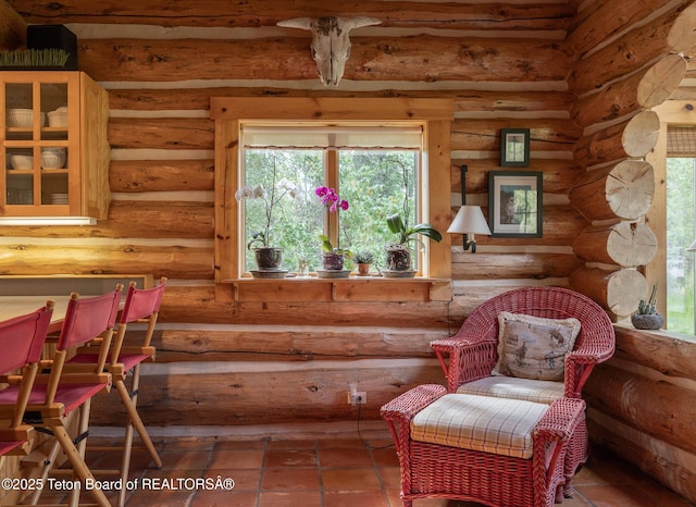 3760 N Moose-Wilson Rd, Wilson, WY 83014 - living area featuring tile patterned floors and rustic walls