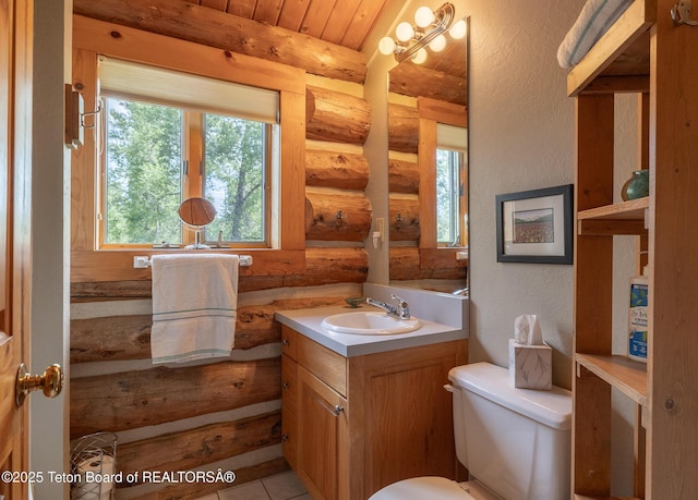 3760 N Moose-Wilson Rd, Wilson, WY 83014 - bathroom with log walls, vanity, and a textured wall