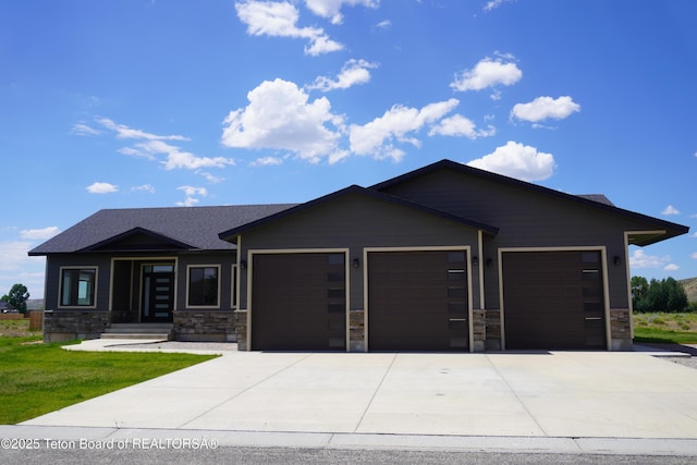 1350 Arroyo, Pinedale, WY 82941 - view of front of house featuring an attached garage, driveway, stone siding, and a front yard