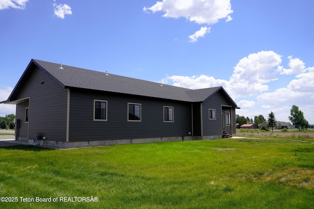 1350 Arroyo, Pinedale, WY 82941 - rear view of house with entry steps, a yard, and roof with shingles