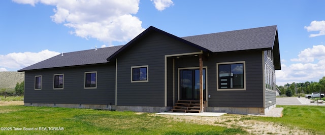 1350 Arroyo, Pinedale, WY 82941 - back of property with a yard, roof with shingles, and entry steps