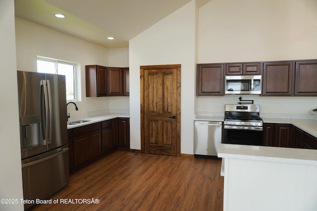 1350 Arroyo, Pinedale, WY 82941 - kitchen with appliances with stainless steel finishes, dark brown cabinets, dark wood-style floors, recessed lighting, and light stone counters