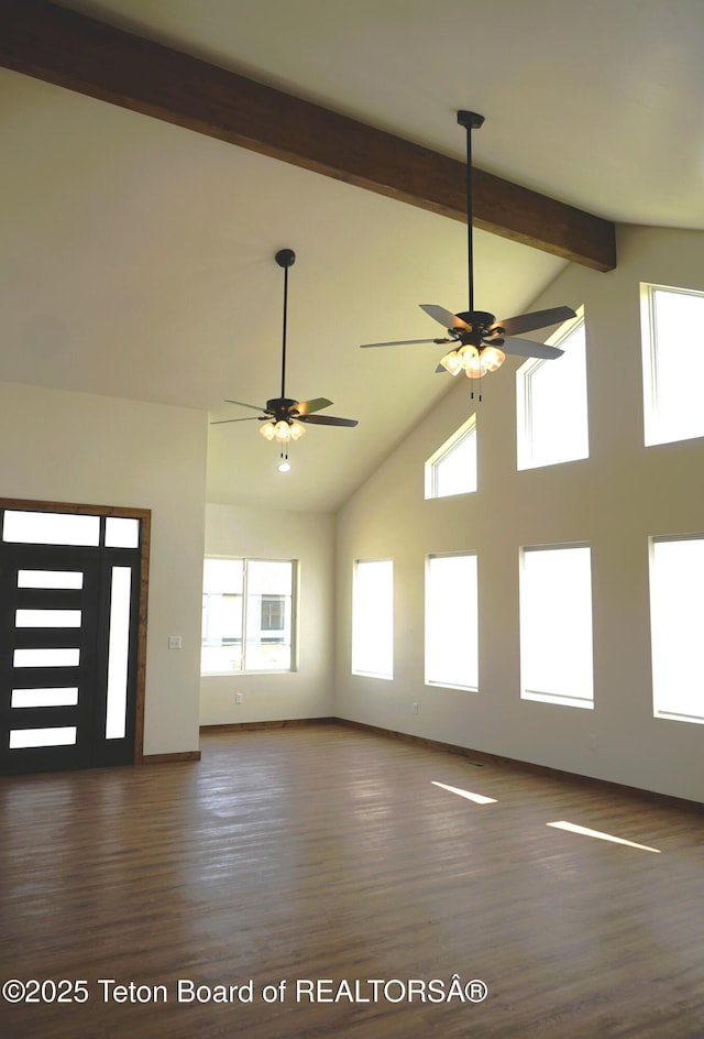 1350 Arroyo, Pinedale, WY 82941 - unfurnished living room featuring a ceiling fan, healthy amount of natural light, beam ceiling, high vaulted ceiling, and wood finished floors