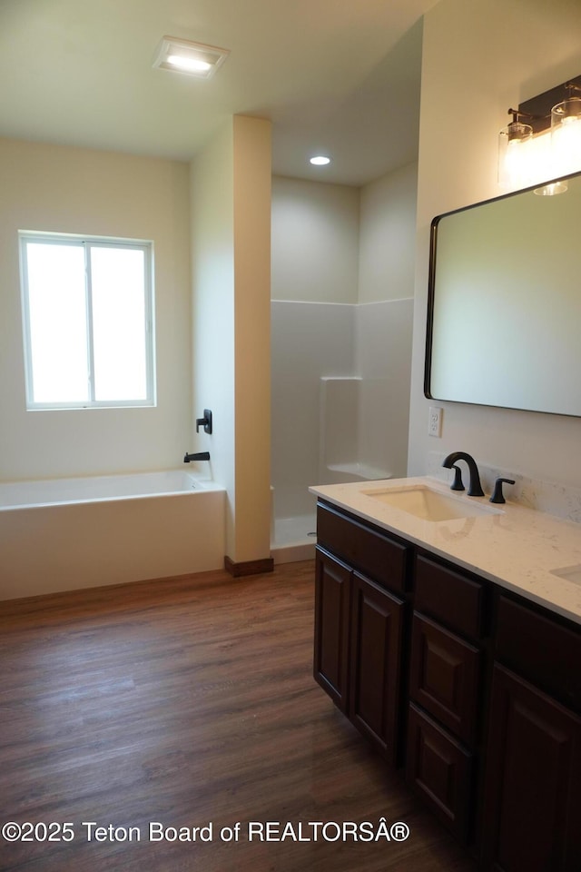 1350 Arroyo, Pinedale, WY 82941 - bathroom featuring wood finished floors, double vanity, a garden tub, and recessed lighting
