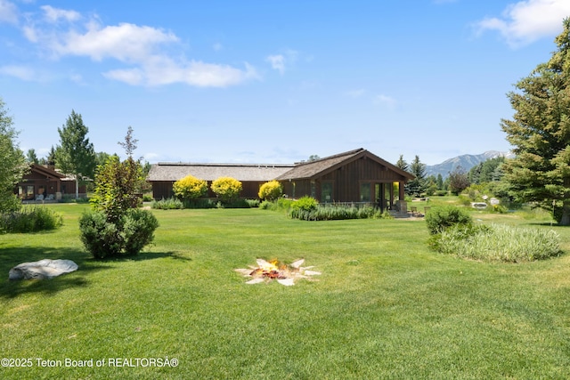 500 E Buckwheat Cir, Jackson, WY 83001 - view of green lawn with a fire pit and a mountain view