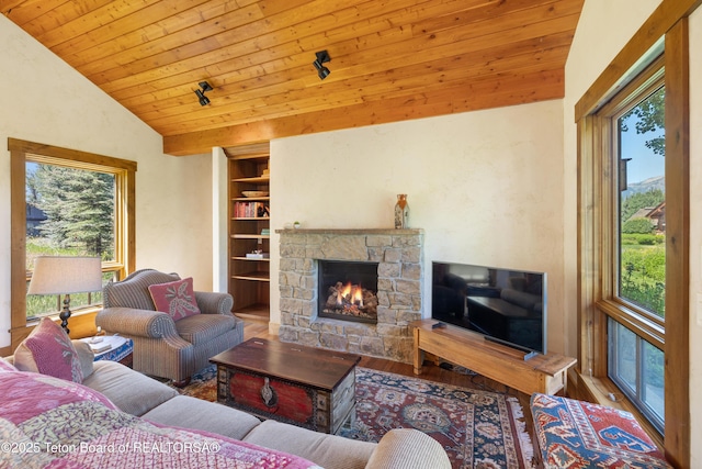 500 E Buckwheat Cir, Jackson, WY 83001 - living area featuring vaulted ceiling, plenty of natural light, wood finished floors, wooden ceiling, and a fireplace