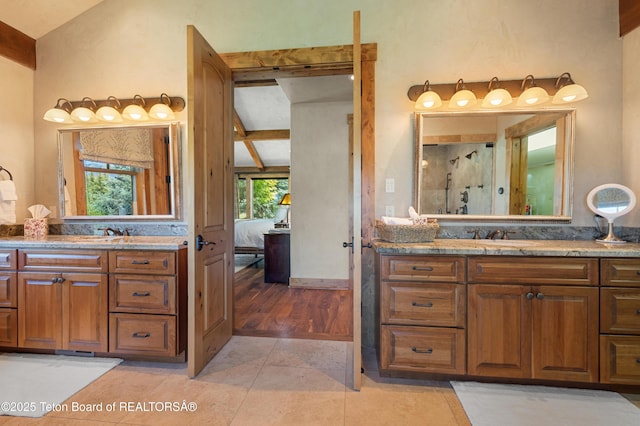 500 E Buckwheat Cir, Jackson, WY 83001 - ensuite bathroom with two vanities, a shower with door, and tile patterned flooring
