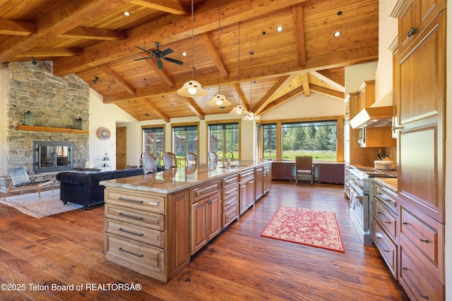 500 E Buckwheat Cir, Jackson, WY 83001 - kitchen with a wooden ceiling with exposed beams, dark wood-style floors, high end stove, an island with sink, and high vaulted ceiling