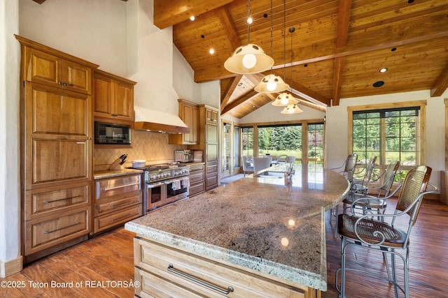 500 E Buckwheat Cir, Jackson, WY 83001 - kitchen featuring double oven range, a wooden ceiling with exposed beams, dark wood-style flooring, light stone countertops, and a kitchen bar