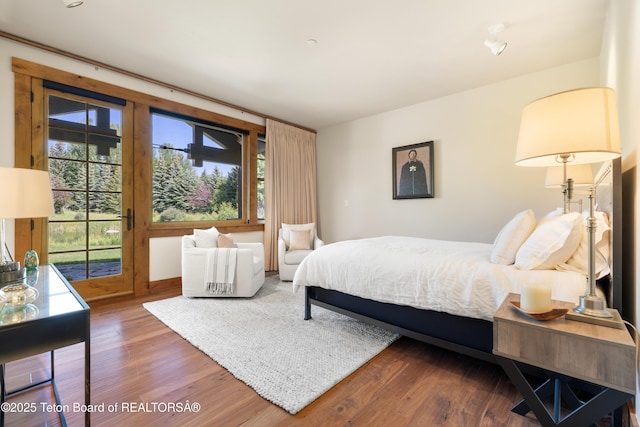 500 E Buckwheat Cir, Jackson, WY 83001 - bedroom with access to exterior and wood finished floors