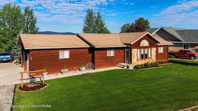 158 Holly Dr, Star Valley Ranch, WY 83127 - back of house with driveway, a lawn, a shingled roof, and entry steps
