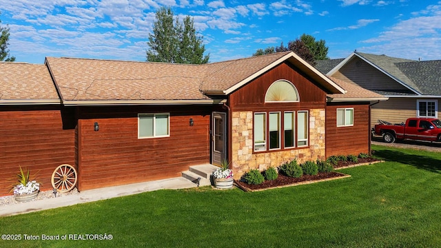 158 Holly Dr, Star Valley Ranch, WY 83127 - view of front of property featuring stone siding, a front lawn, and roof with shingles