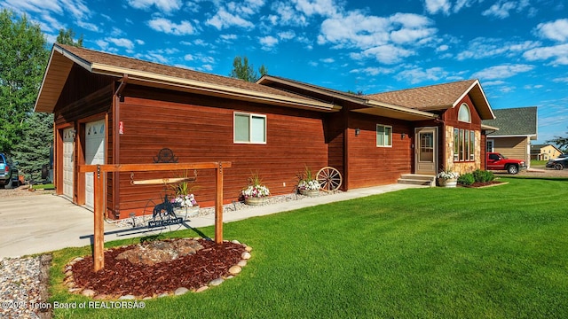 158 Holly Dr, Star Valley Ranch, WY 83127 - rear view of property featuring concrete driveway, a yard, entry steps, and a shingled roof