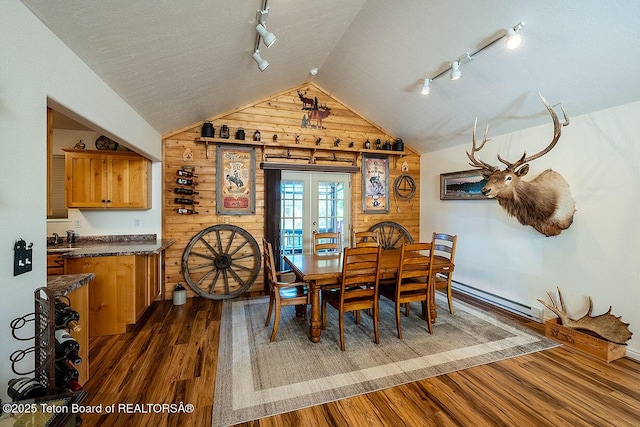 158 Holly Dr, Star Valley Ranch, WY 83127 - dining room featuring track lighting, a baseboard radiator, lofted ceiling, dark wood-style flooring, and french doors