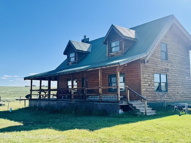 109 E Fontenelle Dr, Daniel, WY 83115 - view of front of home featuring a chimney, a front lawn, a porch, and a metal roof