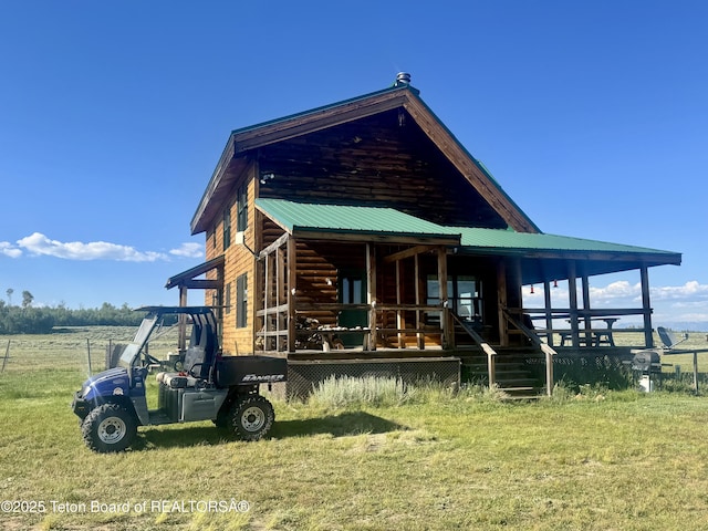 109 E Fontenelle Dr, Daniel, WY 83115 - view of front of home with covered porch, a metal roof, and a front yard