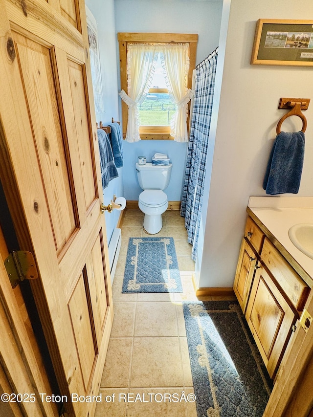 109 E Fontenelle Dr, Daniel, WY 83115 - full bathroom featuring vanity, tile patterned floors, a baseboard heating unit, and a shower with shower curtain