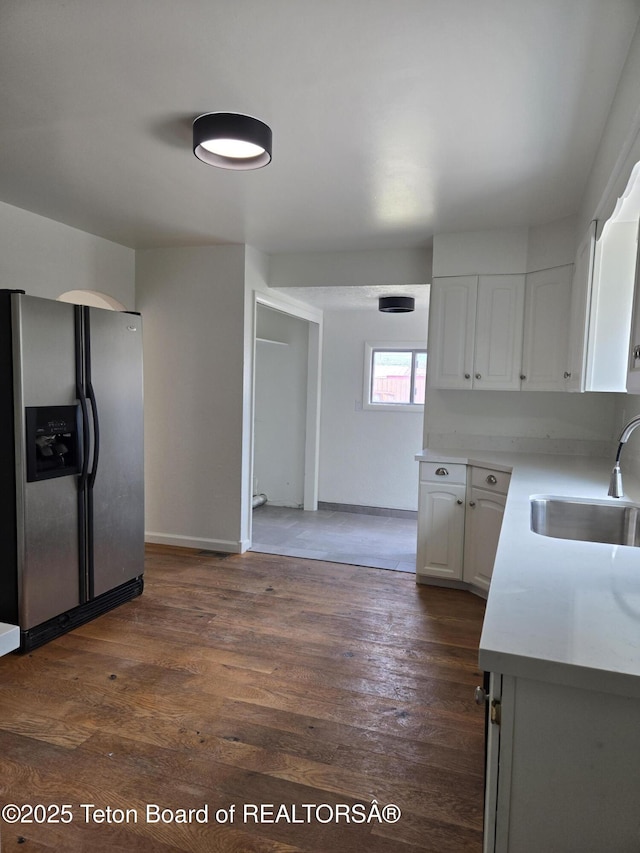 6270 S 3rd St, Tetonia, ID 83452 - kitchen featuring stainless steel refrigerator with ice dispenser, light countertops, white cabinets, and dark wood-type flooring