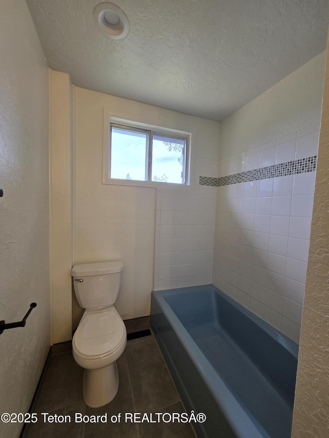 6270 S 3rd St, Tetonia, ID 83452 - full bathroom featuring a tub, a textured ceiling, and tile patterned flooring