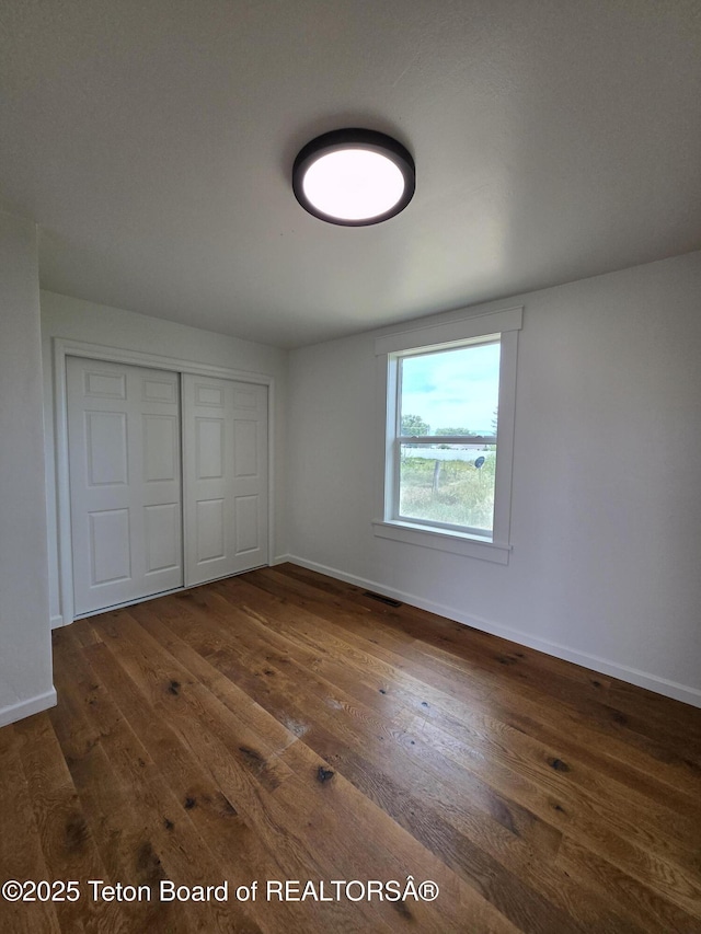 6270 S 3rd St, Tetonia, ID 83452 - unfurnished bedroom featuring dark wood-type flooring and a closet