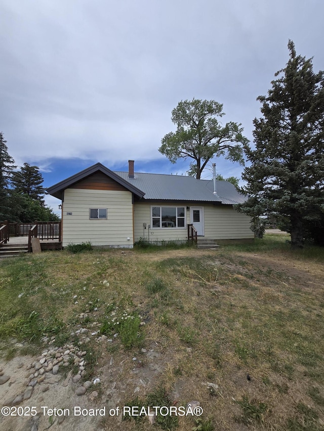 6270 S 3rd St, Tetonia, ID 83452 - rear view of property featuring a deck, a metal roof, a chimney, and entry steps