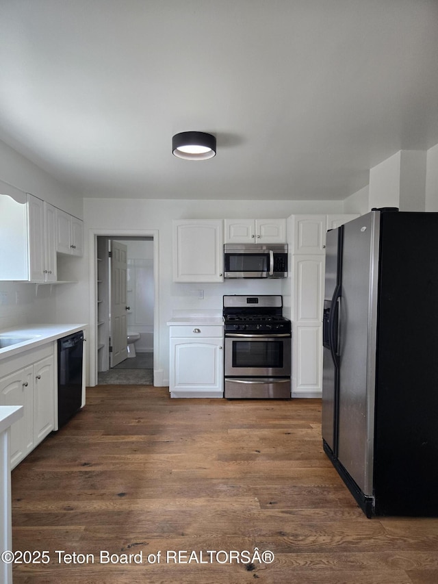 6270 S 3rd St, Tetonia, ID 83452 - kitchen featuring appliances with stainless steel finishes, white cabinetry, and dark wood-type flooring