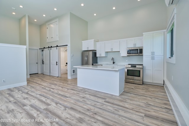 151 Stonefly Ln, Swan Valley, ID 83449 - kitchen with a towering ceiling, stainless steel appliances, a center island, light wood-style flooring, and light countertops