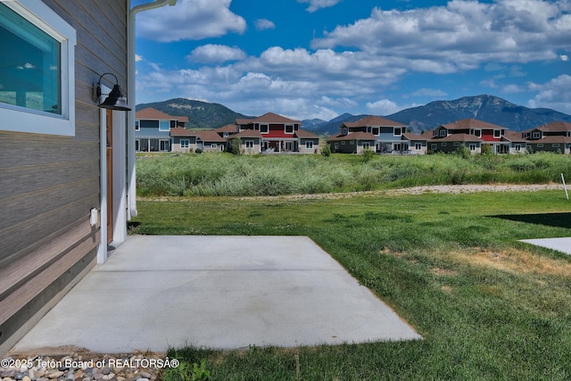 151 Stonefly Ln, Swan Valley, ID 83449 - view of grassy yard featuring a mountain view, a residential view, and a patio area