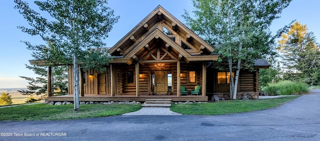 8157 Ripplinger Rd, Driggs, ID 83422 - cabin with log siding and covered porch