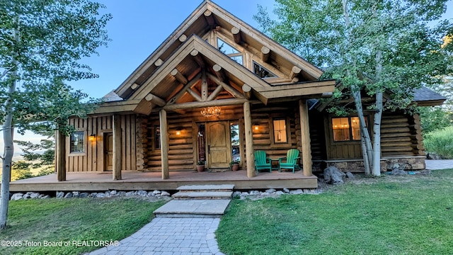 8157 Ripplinger Rd, Driggs, ID 83422 - view of front of property featuring log exterior, a porch, and a front yard