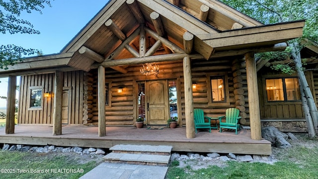 8157 Ripplinger Rd, Driggs, ID 83422 - entrance to property with log exterior and a porch