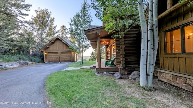 8157 Ripplinger Rd, Driggs, ID 83422 - view of property exterior with log siding, an outdoor structure, and a detached garage