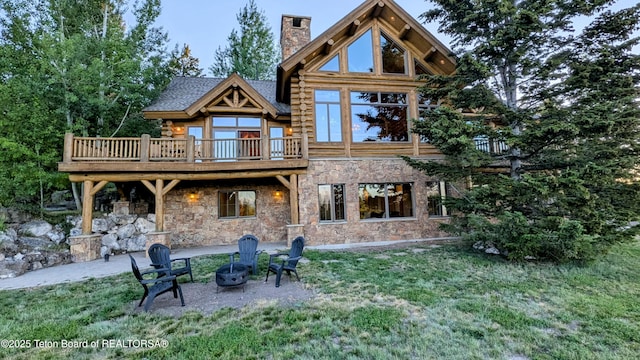 8157 Ripplinger Rd, Driggs, ID 83422 - rear view of property featuring a chimney, stone siding, a yard, and log siding