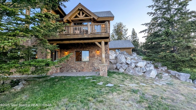 8157 Ripplinger Rd, Driggs, ID 83422 - rear view of house featuring stone siding and a lawn