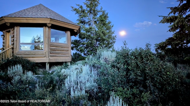 8157 Ripplinger Rd, Driggs, ID 83422 - view of side of home featuring roof with shingles and a sunroom