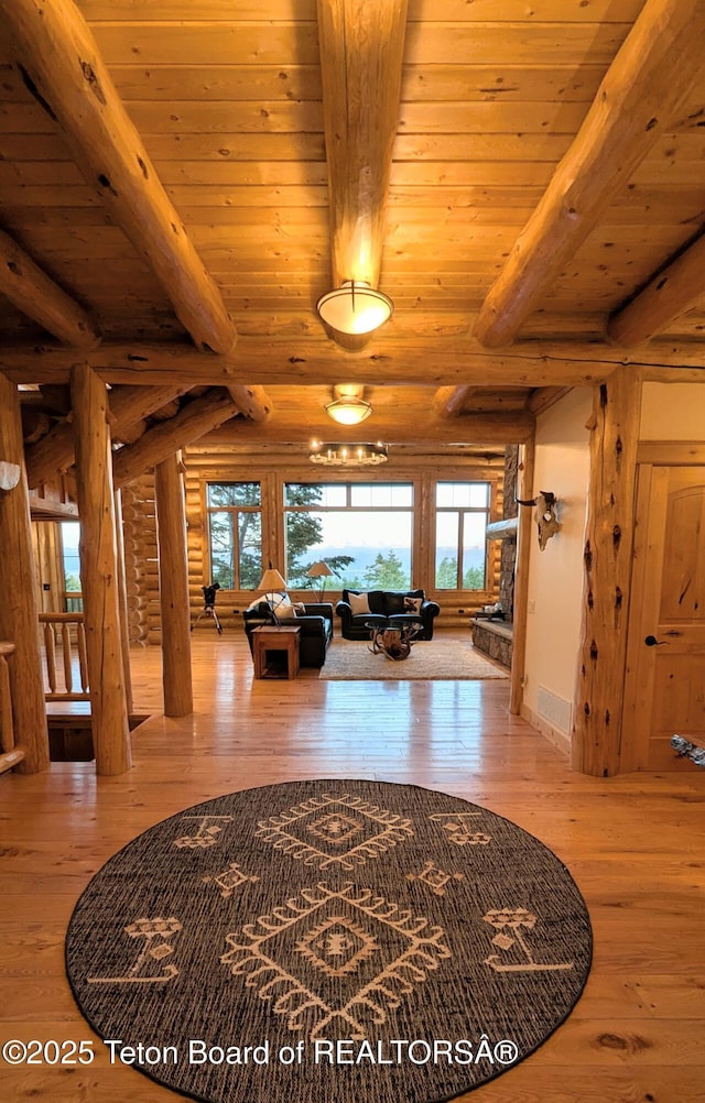 8157 Ripplinger Rd, Driggs, ID 83422 - hall with hardwood / wood-style flooring, rustic walls, and a wooden ceiling with exposed beams