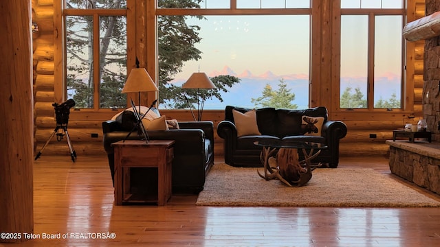 8157 Ripplinger Rd, Driggs, ID 83422 - living room featuring rustic walls, healthy amount of natural light, and hardwood / wood-style floors