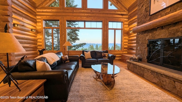8157 Ripplinger Rd, Driggs, ID 83422 - living area with rustic walls, high vaulted ceiling, wood finished floors, a fireplace, and wooden ceiling