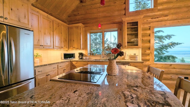 8157 Ripplinger Rd, Driggs, ID 83422 - kitchen featuring stainless steel appliances, wooden ceiling, vaulted ceiling, backsplash, and light stone counters