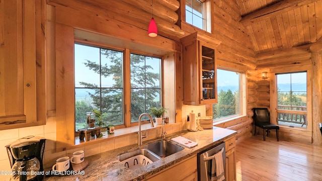 8157 Ripplinger Rd, Driggs, ID 83422 - kitchen with stainless steel dishwasher, wooden ceiling, light wood-style floors, glass insert cabinets, and light stone countertops